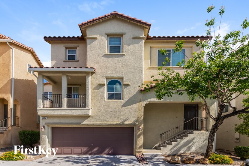 A two-story house with a garage is for sale.
