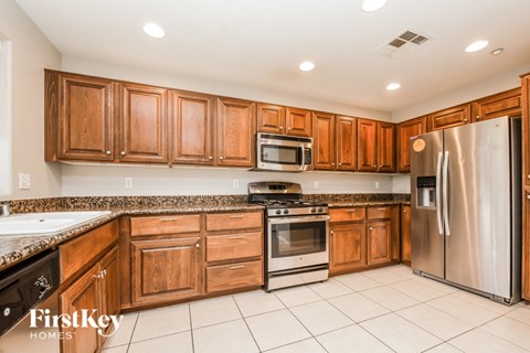 A kitchen with wooden cabinets and stainless steel appliances.