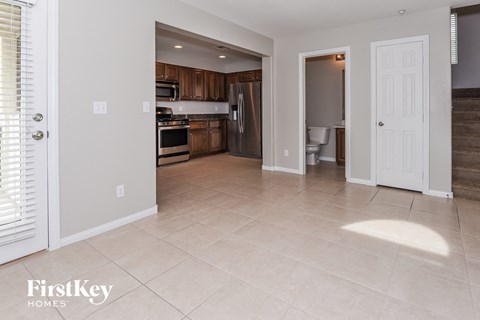 A kitchen with wooden cabinets and a tile floor.