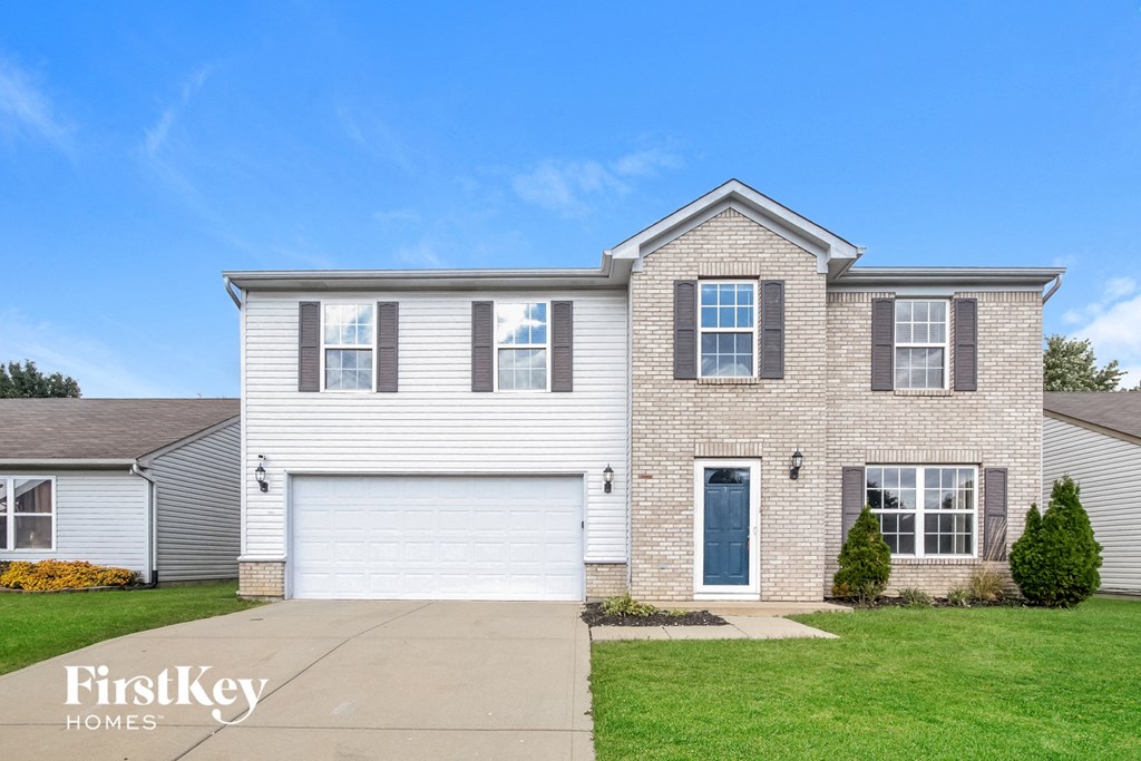 A two-story house with a garage is for sale.