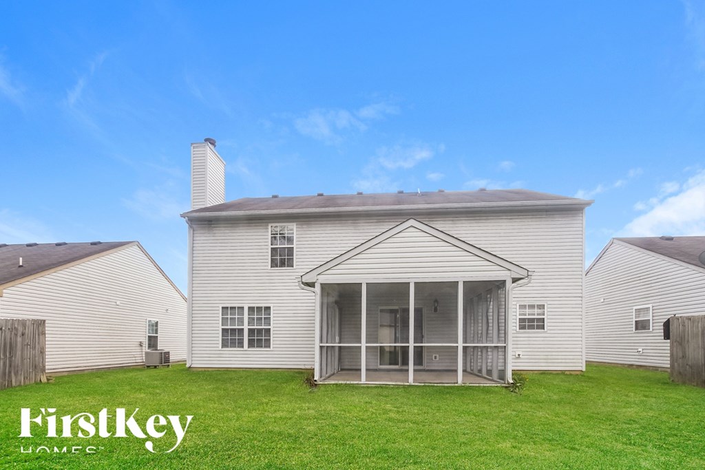 A house with a white exterior and a covered patio is for sale by FirstKey Homes.