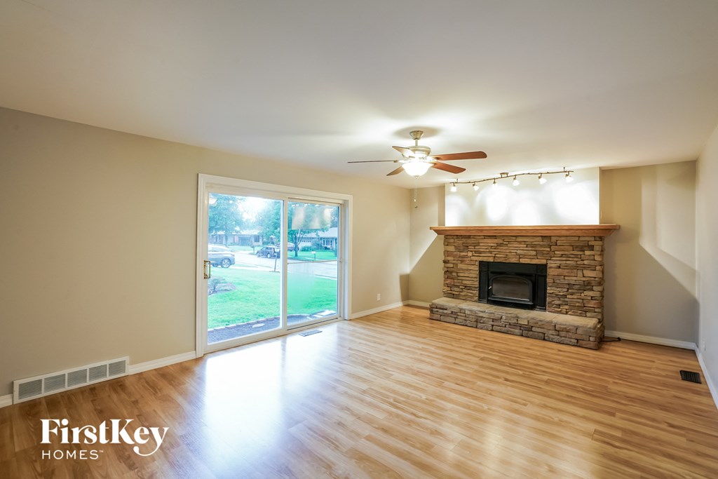 A spacious living room with a fireplace and sliding glass doors.