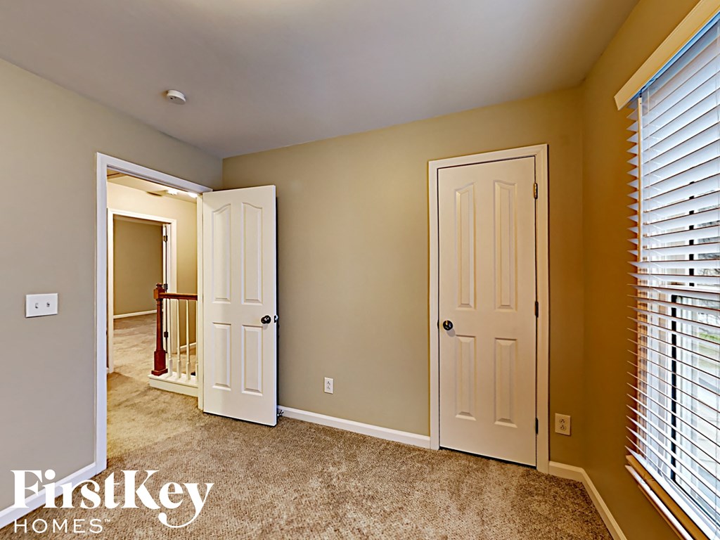 the master bedroom has two closets and a door to the hallway