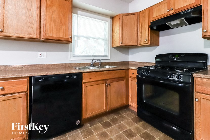 a kitchen with black appliances and wooden cabinets