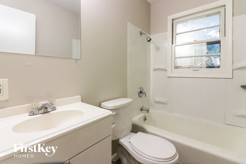 a white bathroom with a sink toilet and tub
