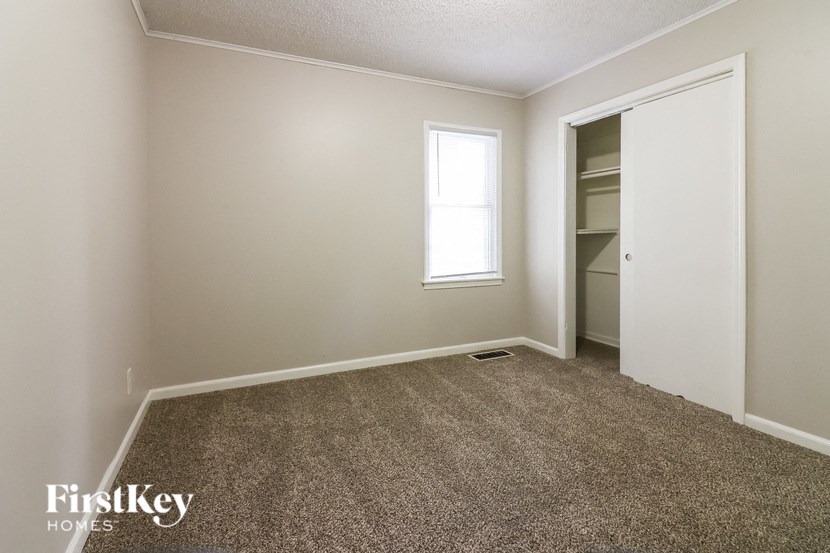 a empty room with a closet and a window