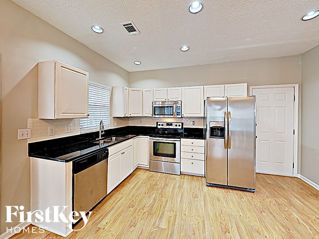 A kitchen with wooden cabinets and stainless steel appliances.