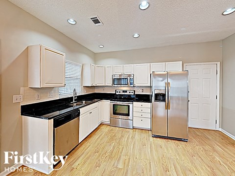 A kitchen with wooden cabinets and stainless steel appliances.