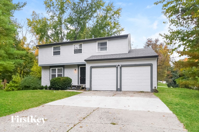 A two-story house with a garage is for sale.