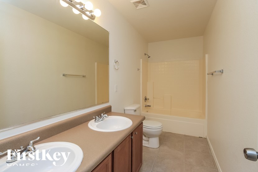 A bathroom with a sink, toilet, and shower.