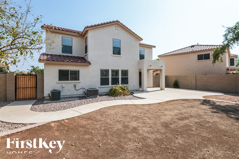 A house with a brown roof and a white exterior is shown.