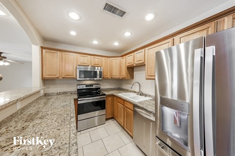 a kitchen with stainless steel appliances and wooden cabinets