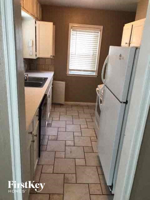 a small kitchen with a refrigerator and a sink
