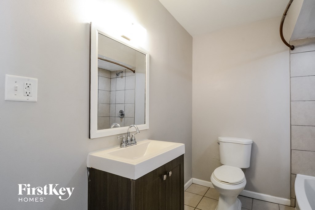 a bathroom with a sink and a toilet and a mirror