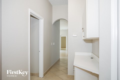 A white kitchen with a sink and cabinets.