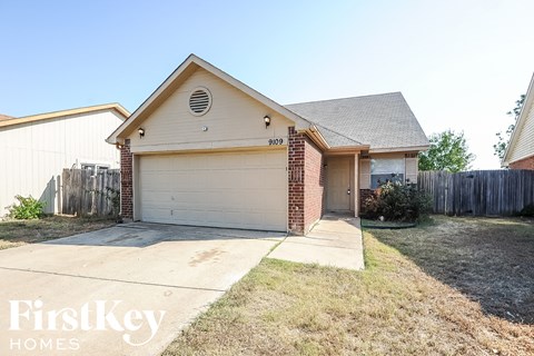 a home with a driveway and a white garage door
