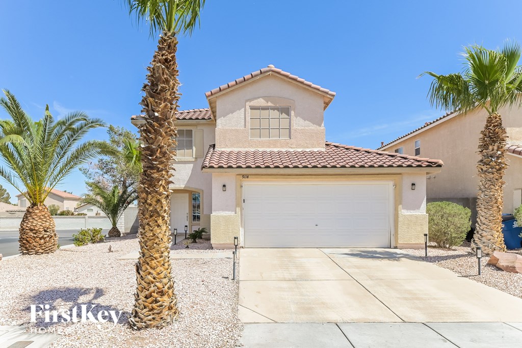 A house with a palm tree in front of it.