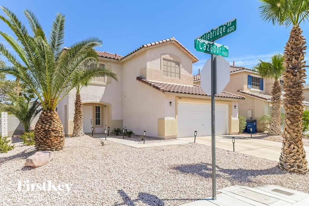 A house with a palm tree in front of it.