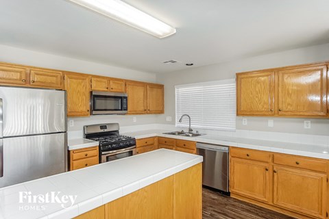 A kitchen with wooden cabinets and stainless steel appliances.