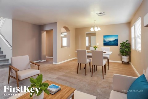 A virtual staged living room with a dining table and chairs.