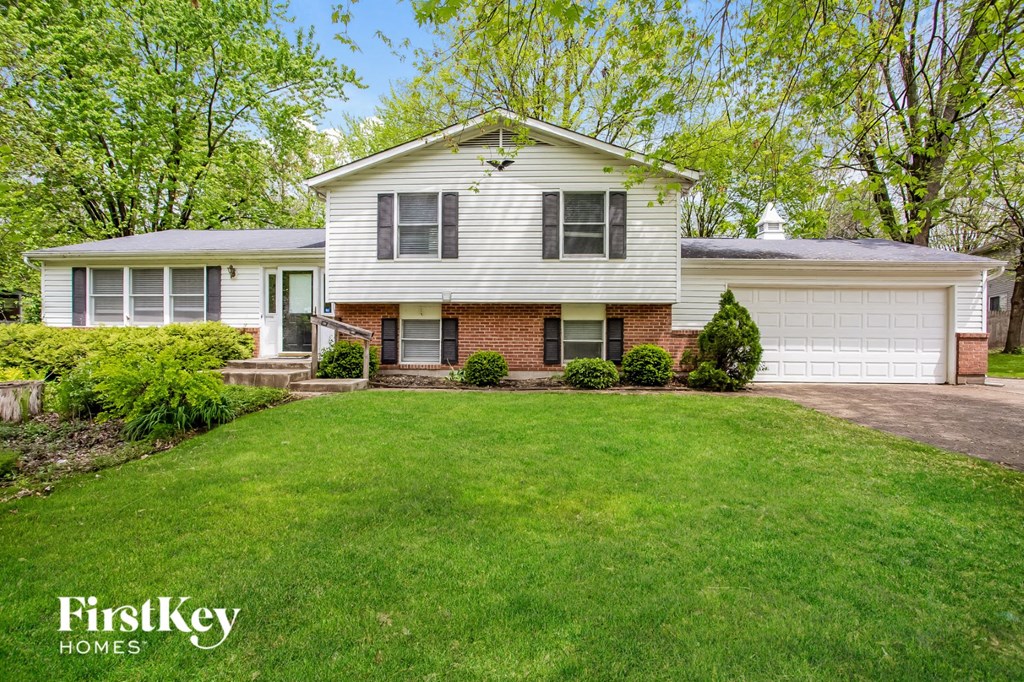 a white house with a lawn in front of it