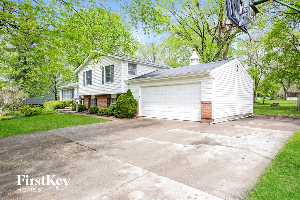 a white house with a driveway in front of it