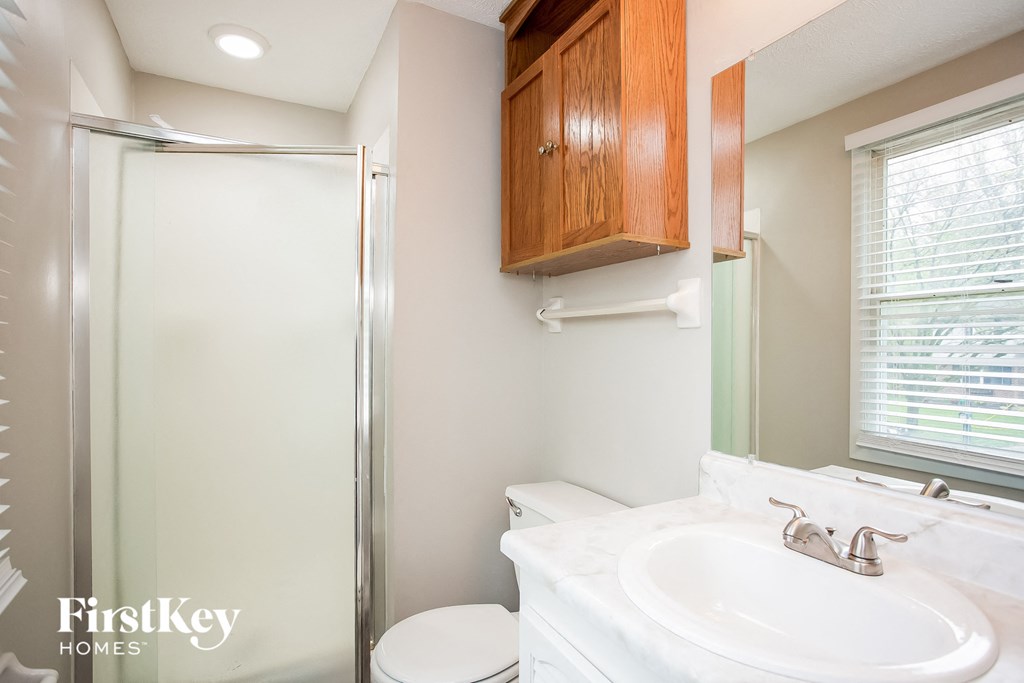 a bathroom with a sink and a shower and a toilet