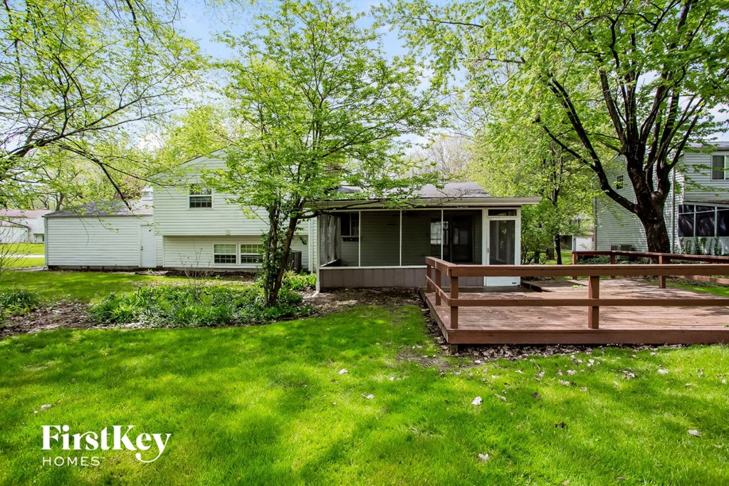 a backyard with a deck and a house