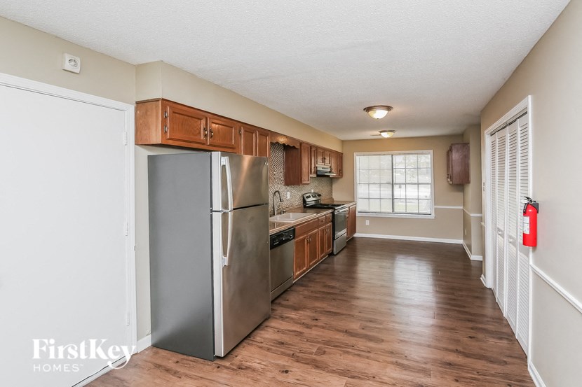 a kitchen with stainless steel appliances and wooden cabinets