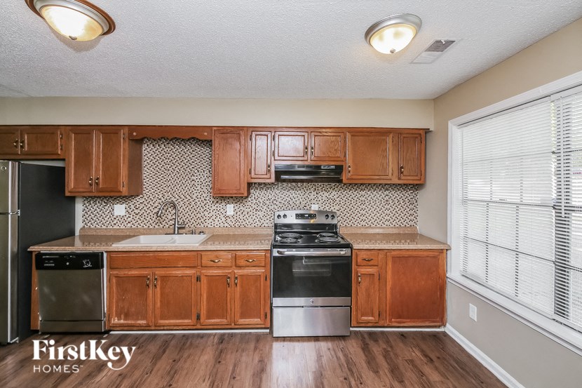 a kitchen with wooden cabinets and stainless steel appliances