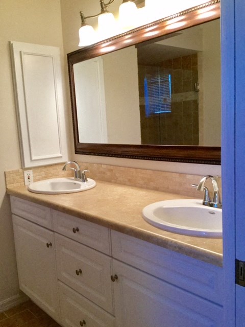 a bathroom with two sinks and a mirror