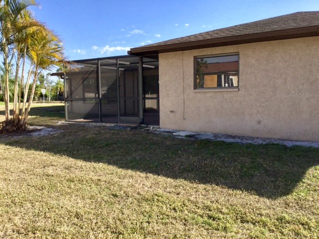 a house with a patio and a palm tree