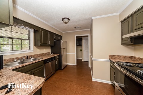 a kitchen with black cabinets and stainless steel appliances and granite counter tops
