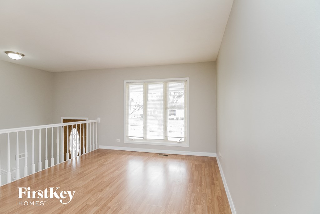 A room with a window and wooden floors.