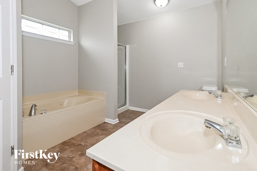a bathroom with a sink and a tub and a mirror