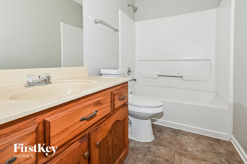 a bathroom with a sink toilet and bath tub