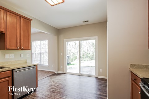 A kitchen with wooden cabinets and a dishwasher.
