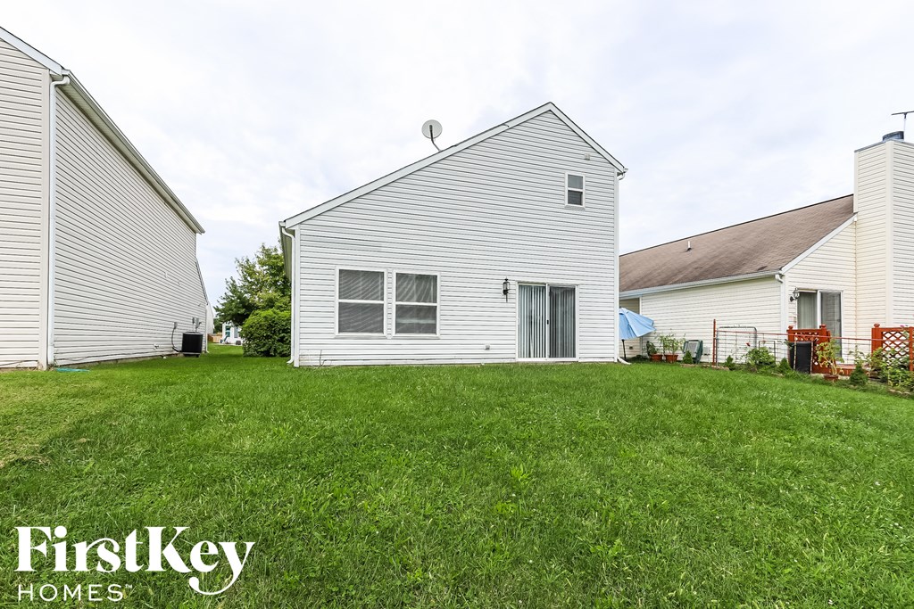 a white house with a yard in front of it