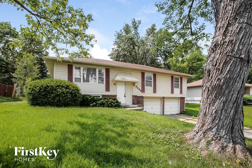 a white and with a tree in the yard