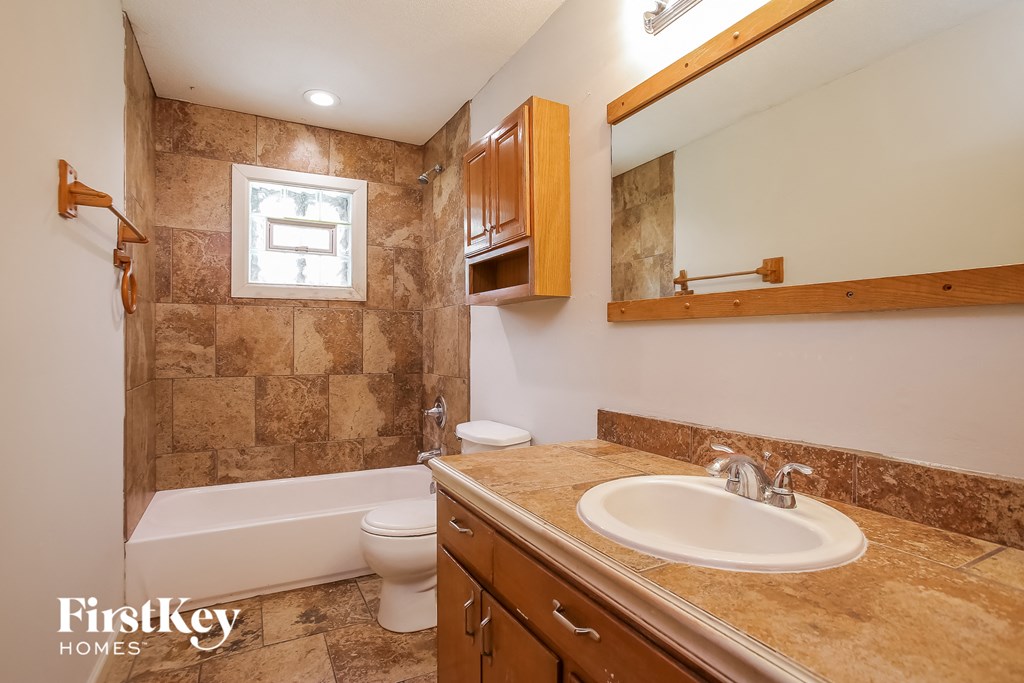 a bathroom with a sink and a toilet and a bath tub
