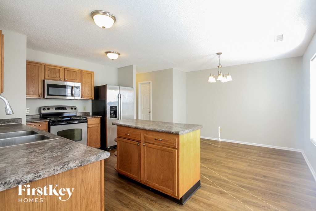 a kitchen with wooden cabinets and stainless steel appliances