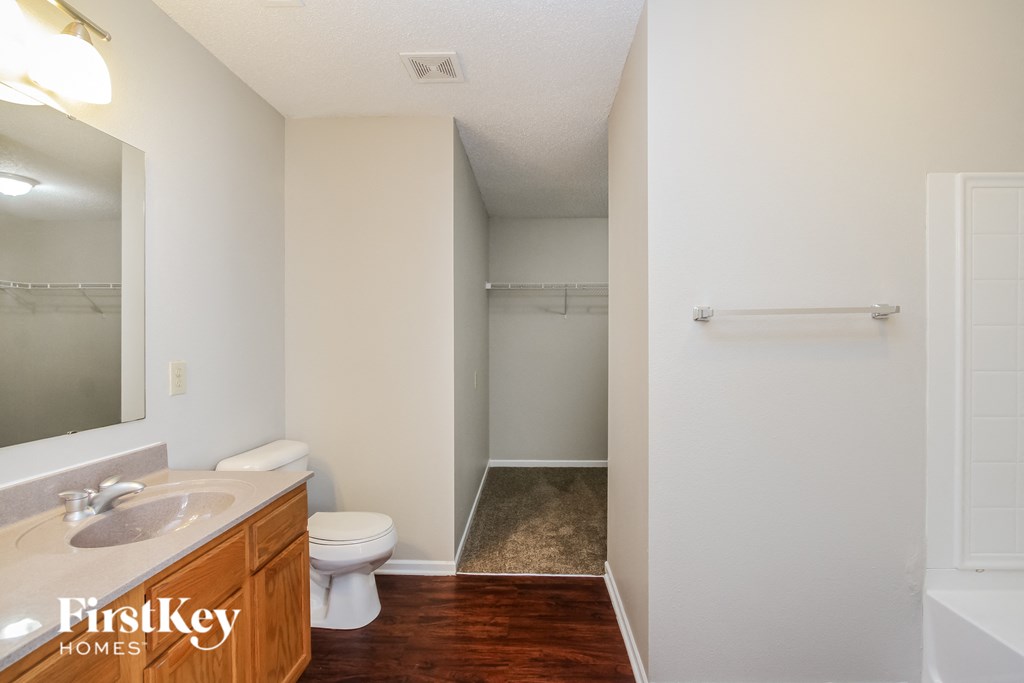a bathroom with a toilet and a sink and a shower