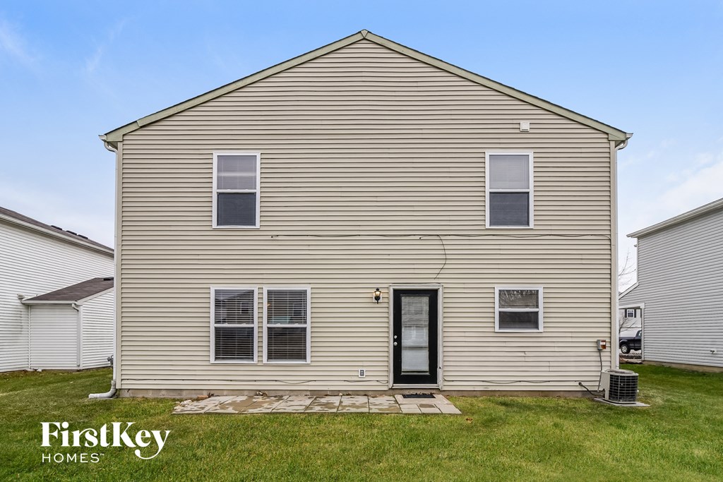 side view of a house with a yard in front of it