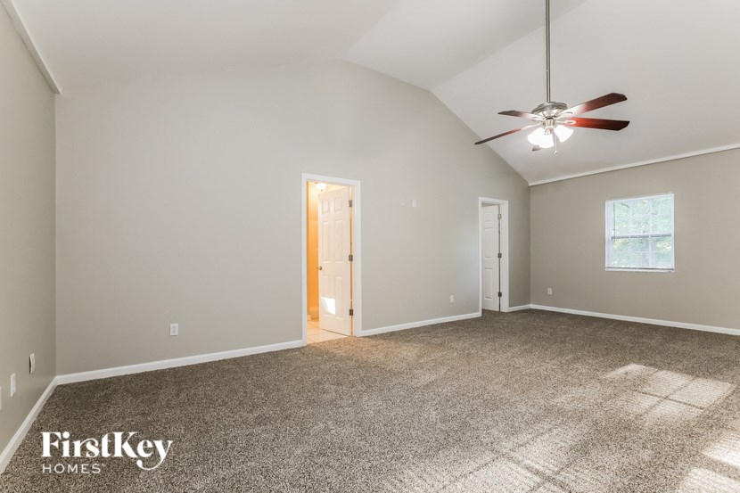 the master bedroom is spacious and has a ceiling fan