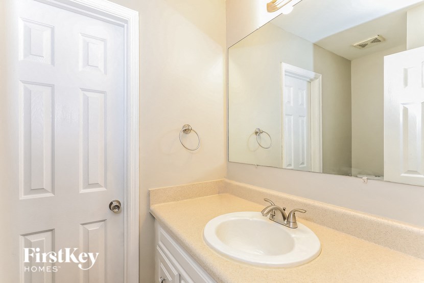 a white bathroom with a sink and a mirror