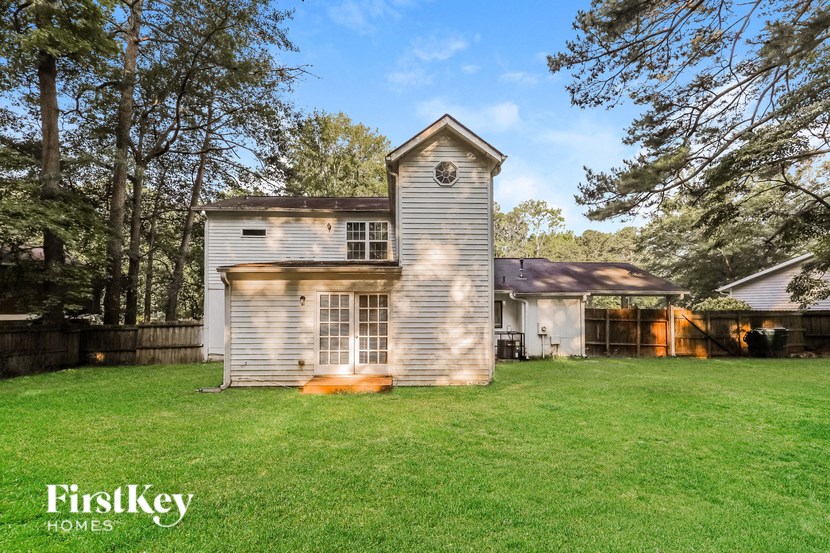 a small house in the middle of a grassy yard