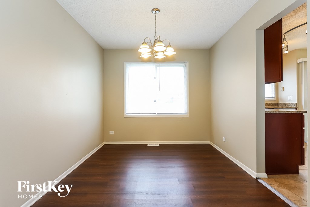 A room with wooden floors and a window.