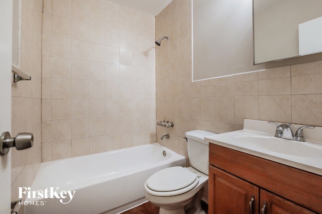 a bathroom with a sink toilet and a bath tub