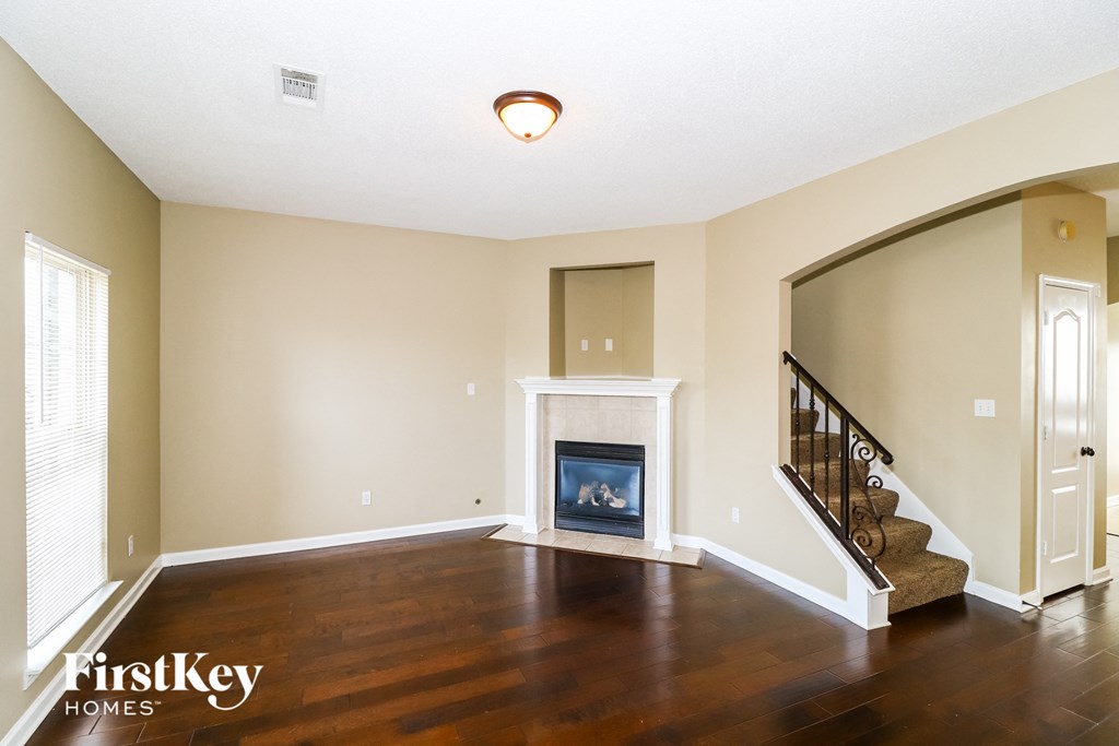 a living room with a fireplace and a staircase