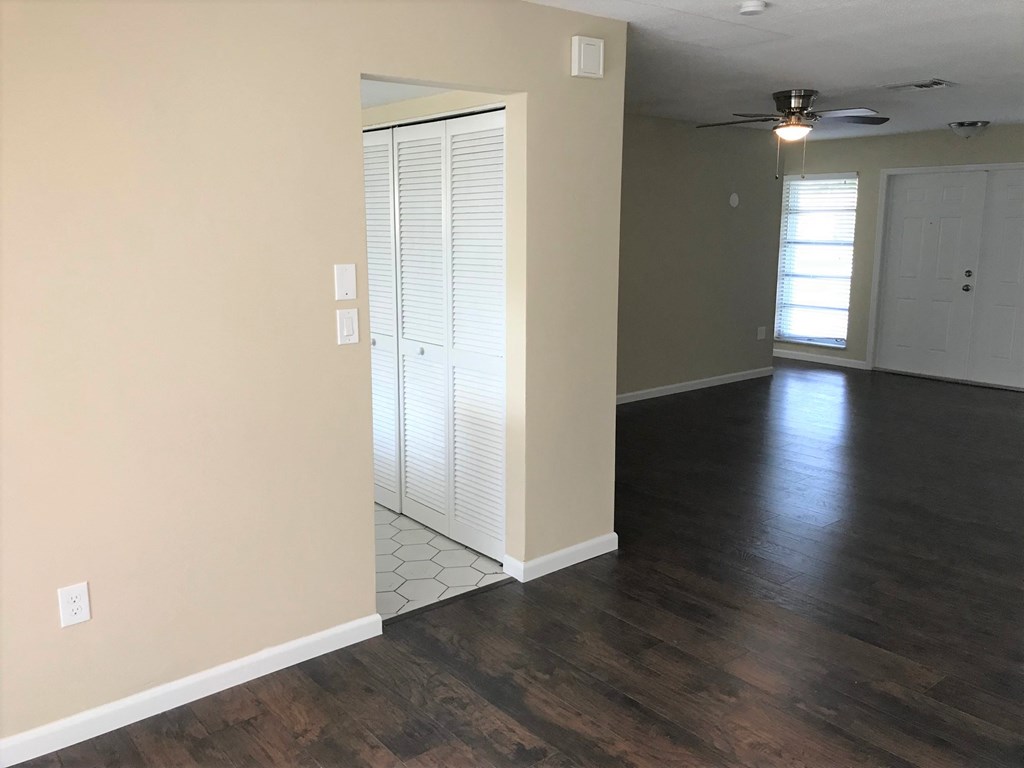 A room with a sliding door and a ceiling fan.